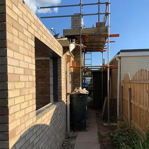 a brick building with scaffolding on top of it