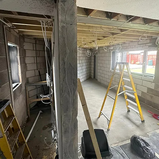 a room with a ladder and a window in it