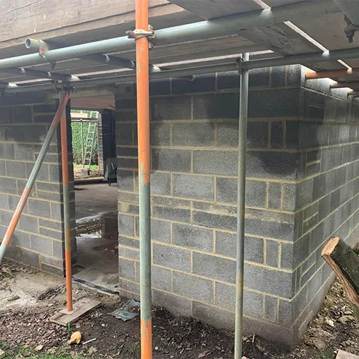 a fire hydrant sitting next to a brick building