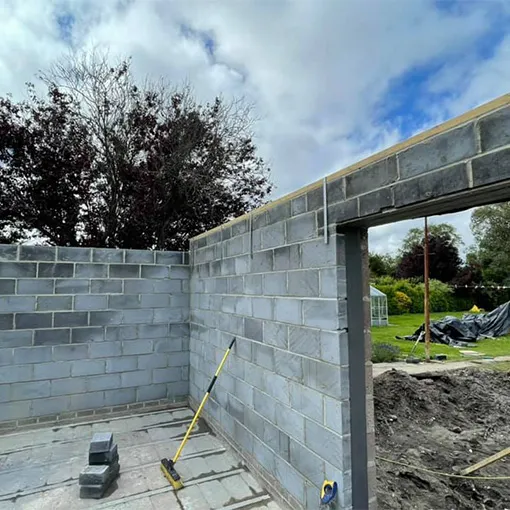 a construction site with a brick wall and a mirror