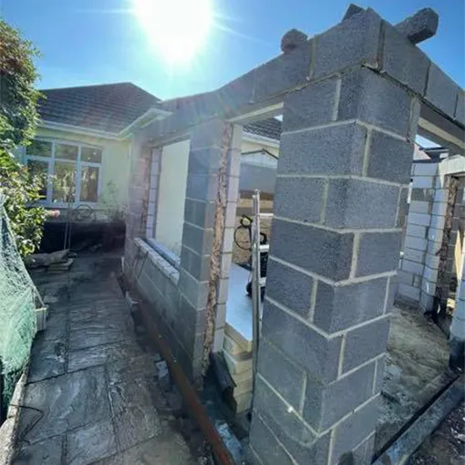 a house that is being built with a brick chimney