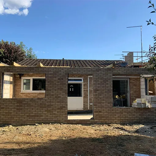 a brick house with a white door and windows